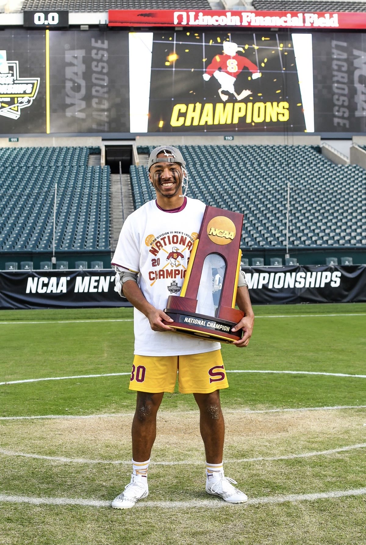 James “Simba” Makawa holding the NCAA national championship trophy at Lincoln Financial Field